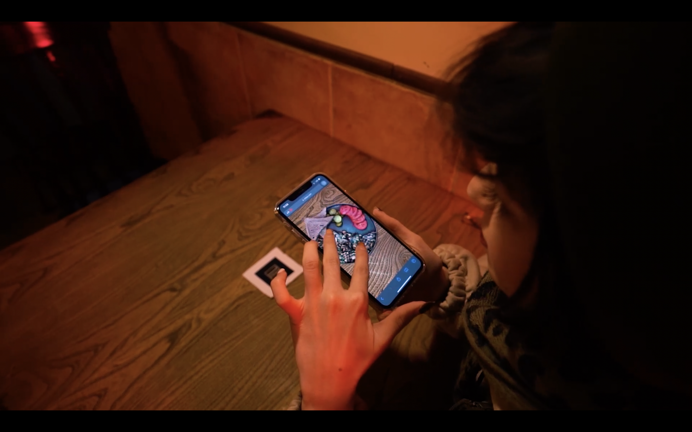 Image of a customer interacting with 3D menu seeing AR item